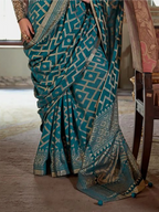 teal blue georgette printed saree pallu and print detail close-up