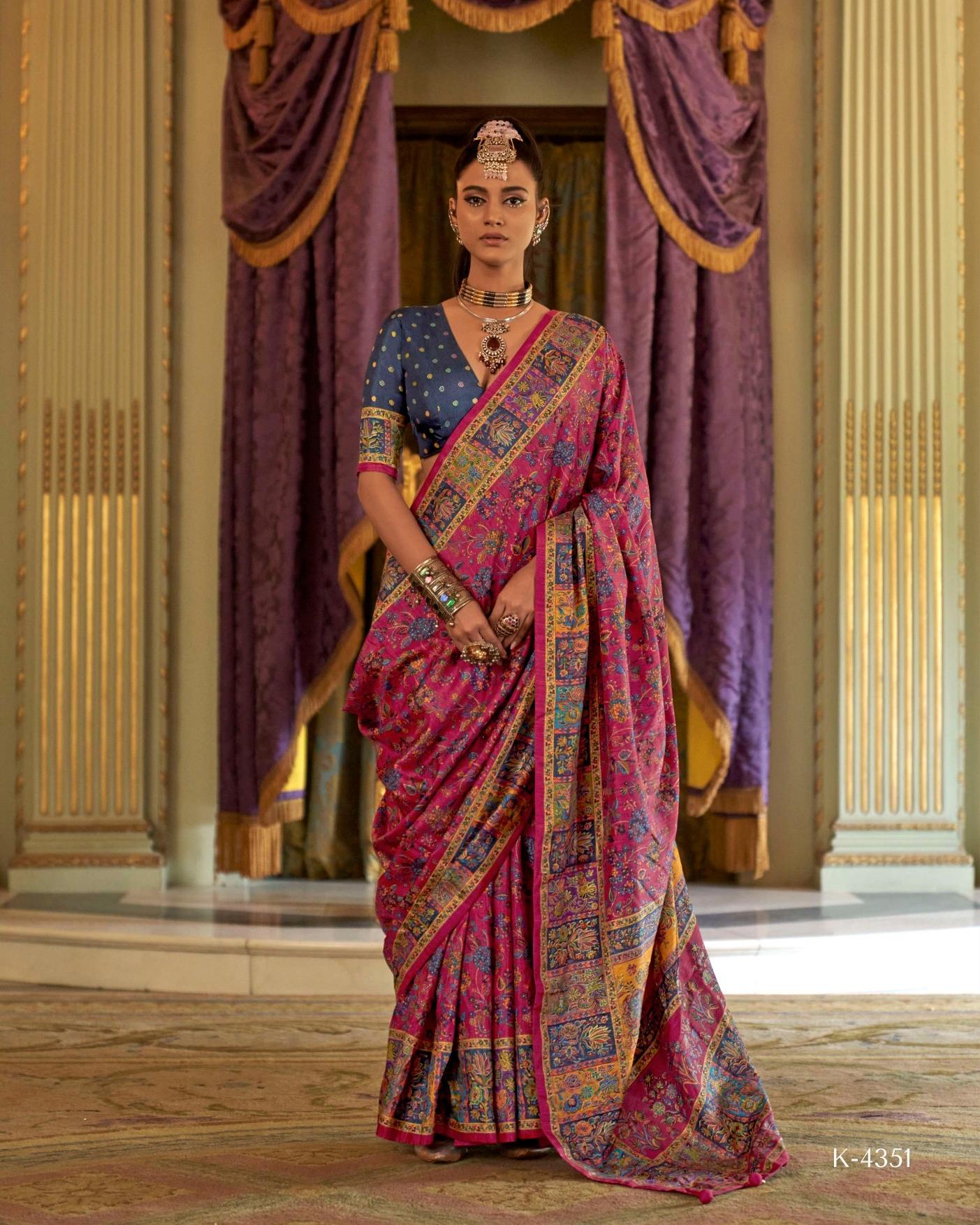 Woman wearing a fuchsia pink Viscose Silk saree with luxury print and Marmo finish for festive occasions.