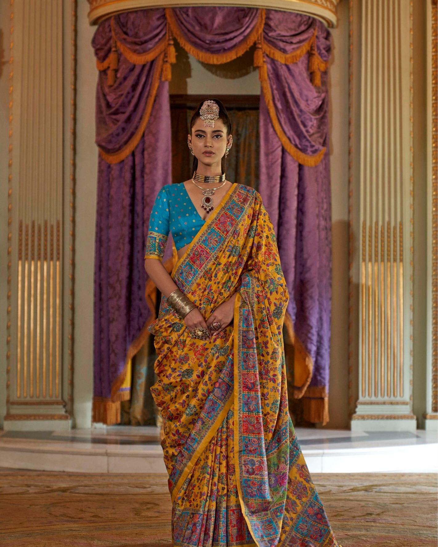 Model showcasing a mustard yellow Viscose Silk saree with luxury floral print and Marmo finish.