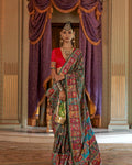 Woman wearing a teal green Viscose Silk saree with luxury floral print and Marmo finish.
