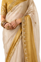 Naksh Creation Cream Gold Fancy Fabric Saree